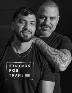 The founders of Strands for Trans pose for a photo in shirts with the pride flag. 